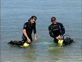 Two divers on the shore