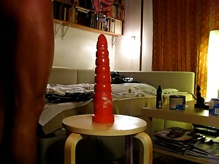 Tattooed guy plays with dildo