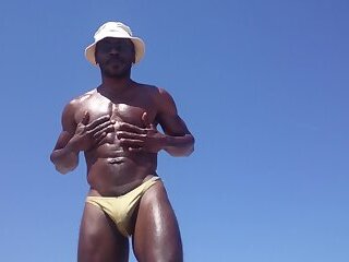 Troy oiling up at the beach