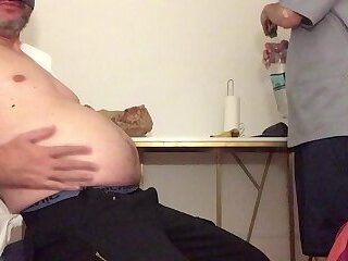 Slim doctor feed his fat patient