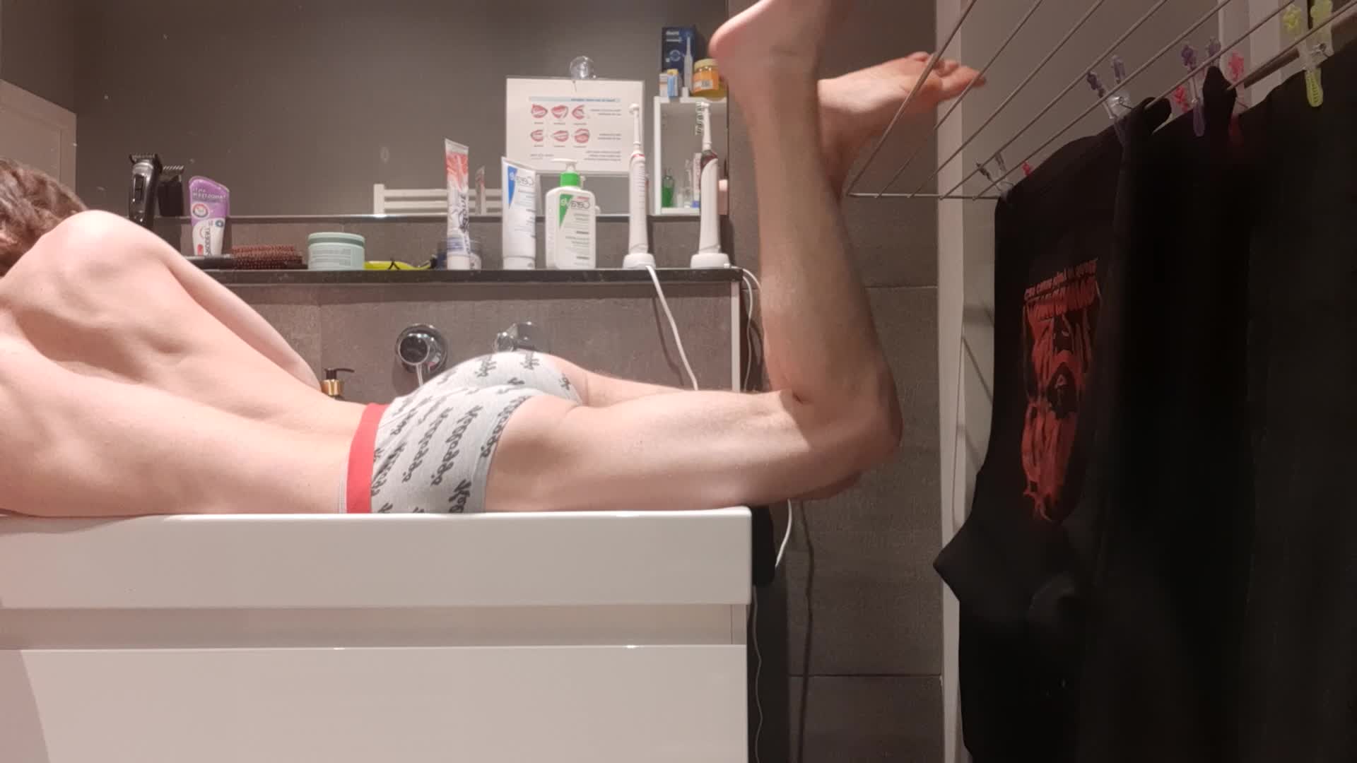 Boy plays with himself and wets his ass under on the sink